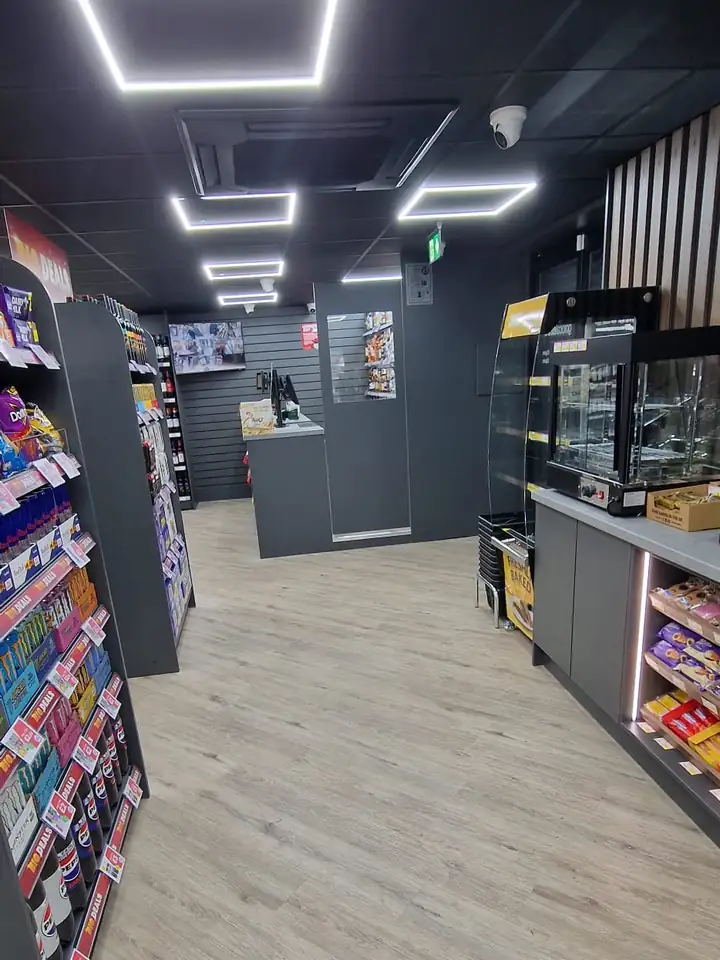 Convenience store refit with gondola shelving and LED ceiling lights